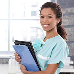 Nurse holding an armful of clipboards